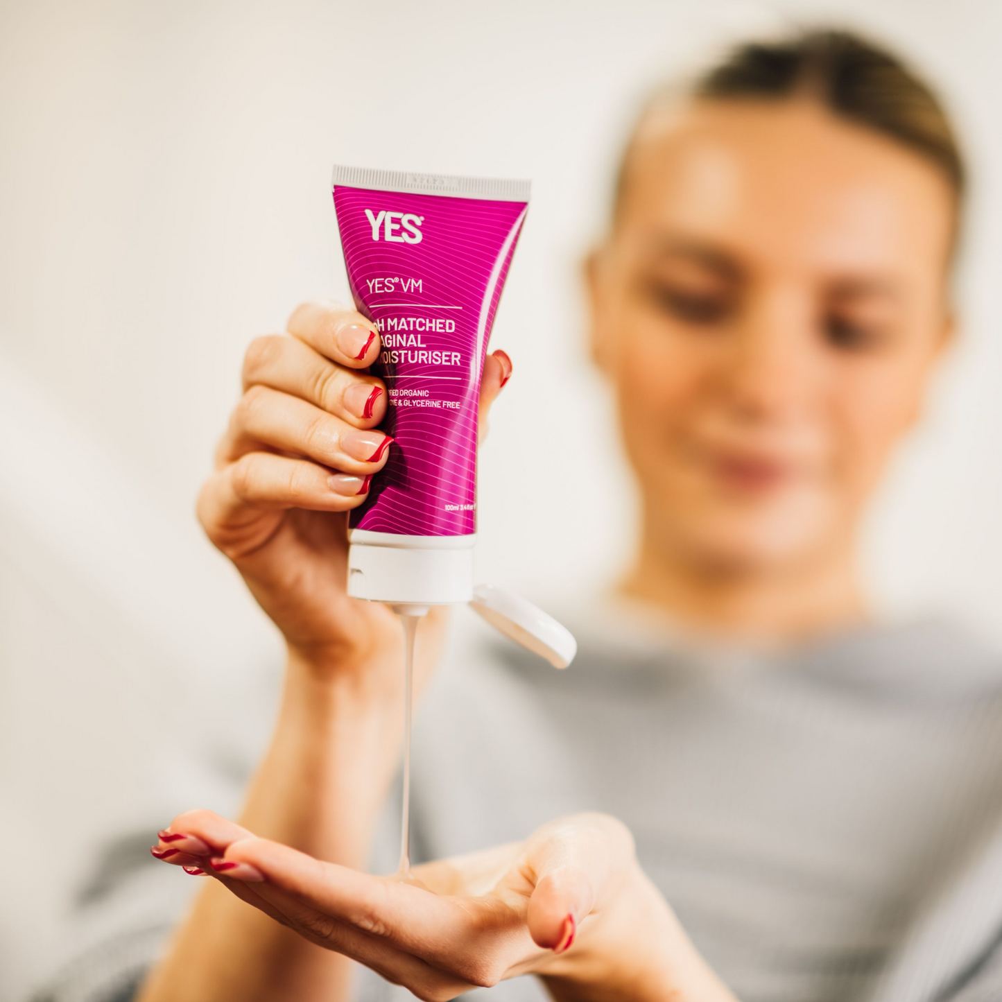 YES VM vaginal moisturiser is being squeezed from the tube into the hand of a woman.